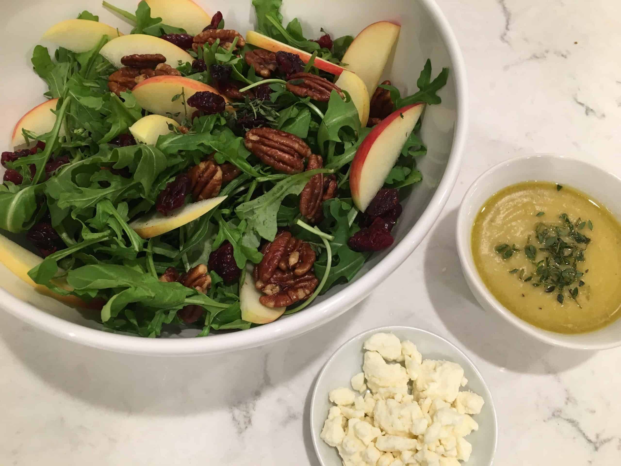 Apple and Cranberry Salad with Feta and Maple Roasted Pecans in a bowl with cheese on the side
