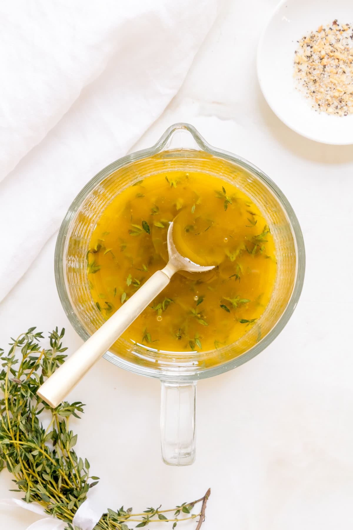 apple cider vinaigrette mixed in a glass measuring cup. 