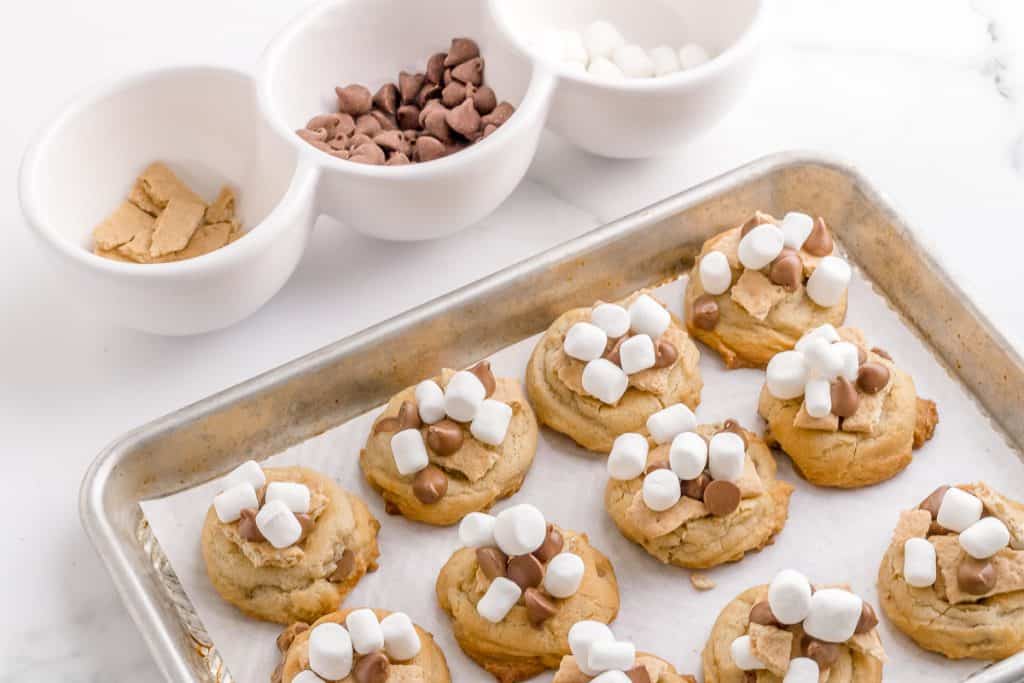 adding graham crackers chocolate and marshmallows to s'mores cookies
