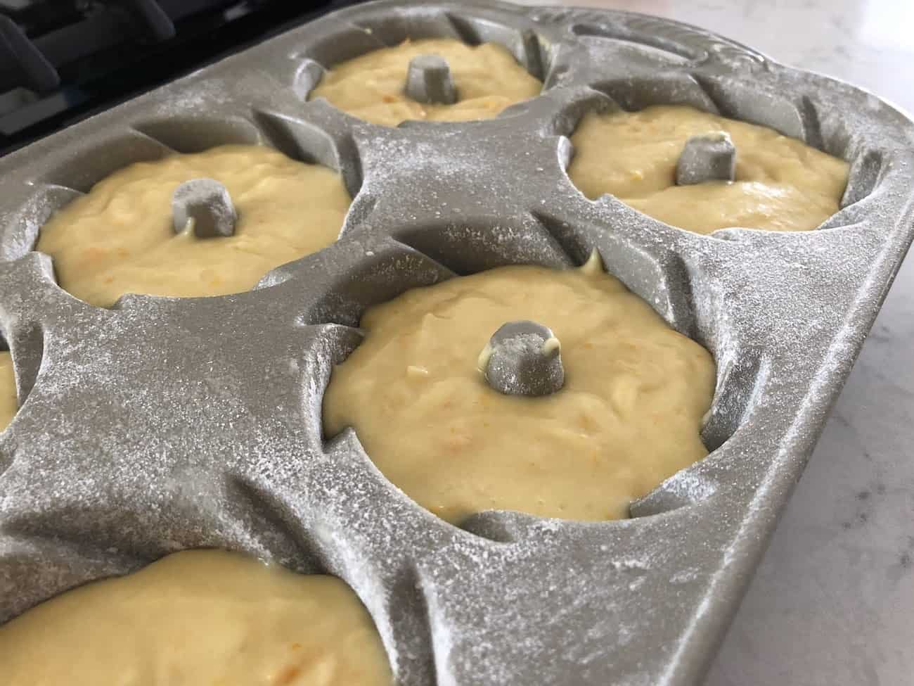 Orange Bundtlette Cakes in molds before going into the oven