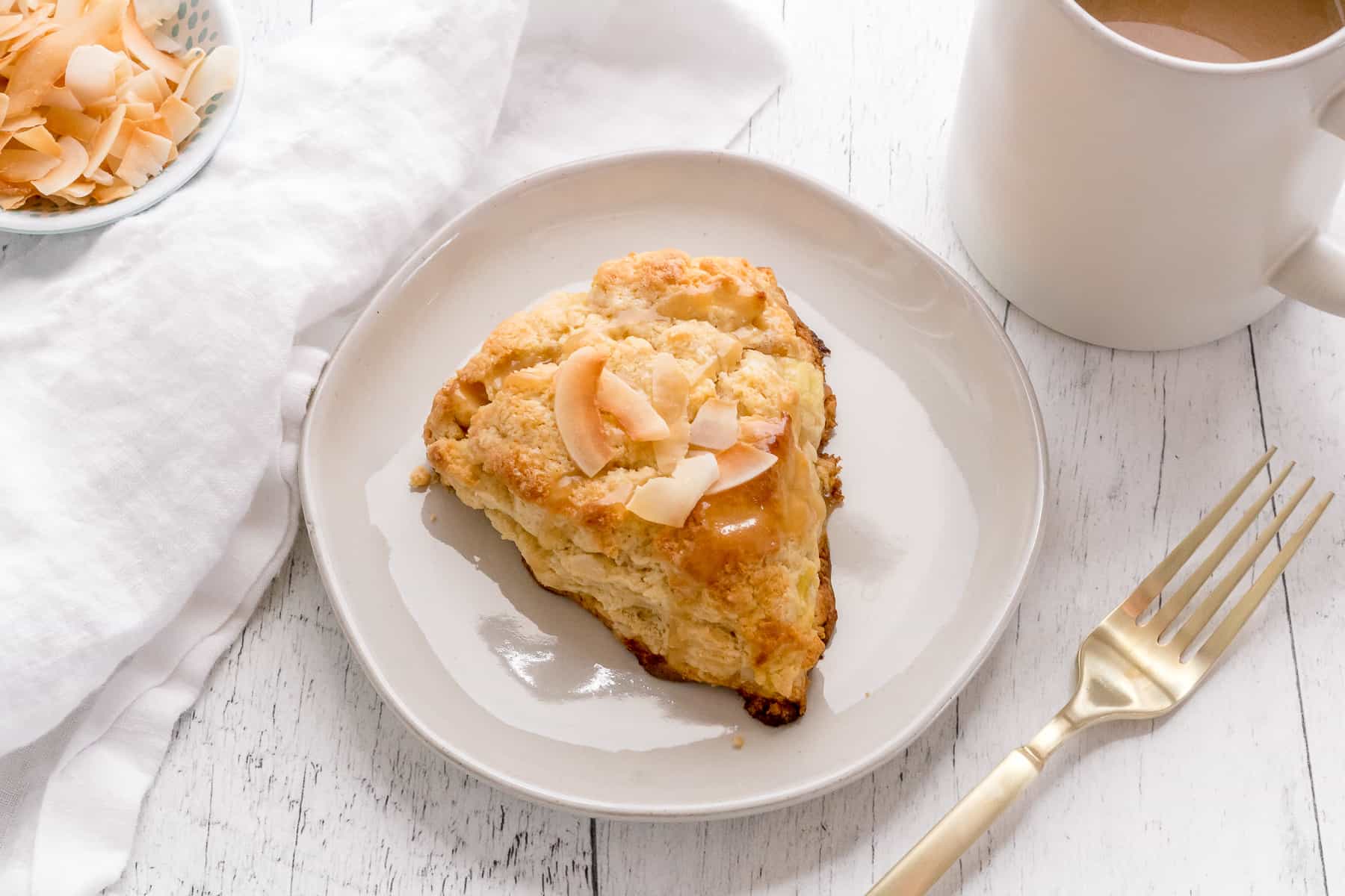 fluffy pineapple coconut scones with coffee and gold fork