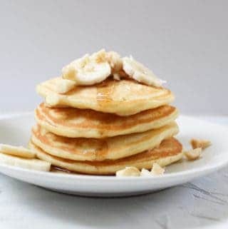 stack of banana macadamia nut pancakes with syrup