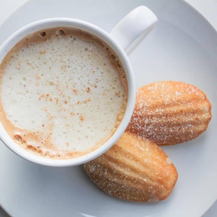 eggnog madeleines on plate with a latte