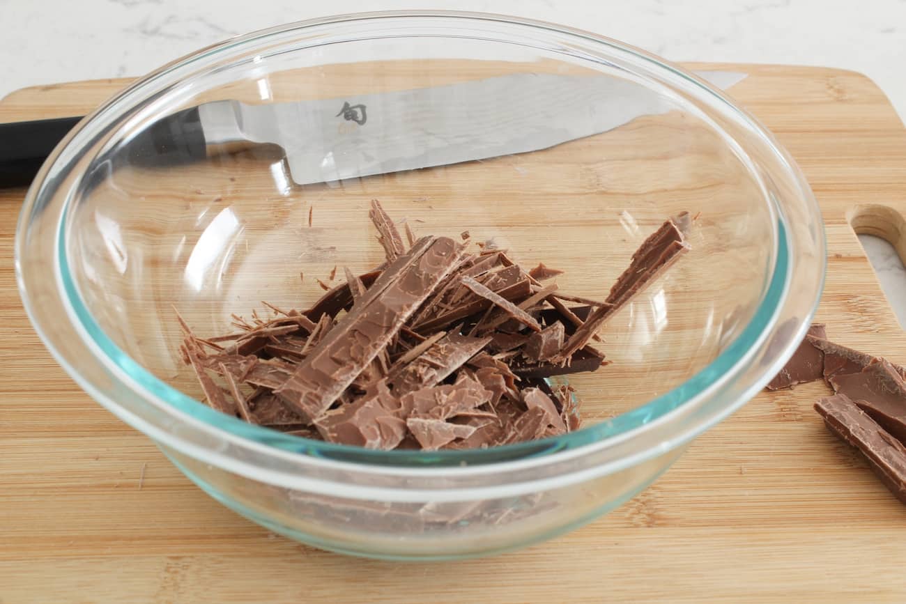 chopped chocolate in glass mixing bowl.
