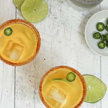 overhead shot of two Spicy Pineapple Citrus Margaritas with slices of lime
