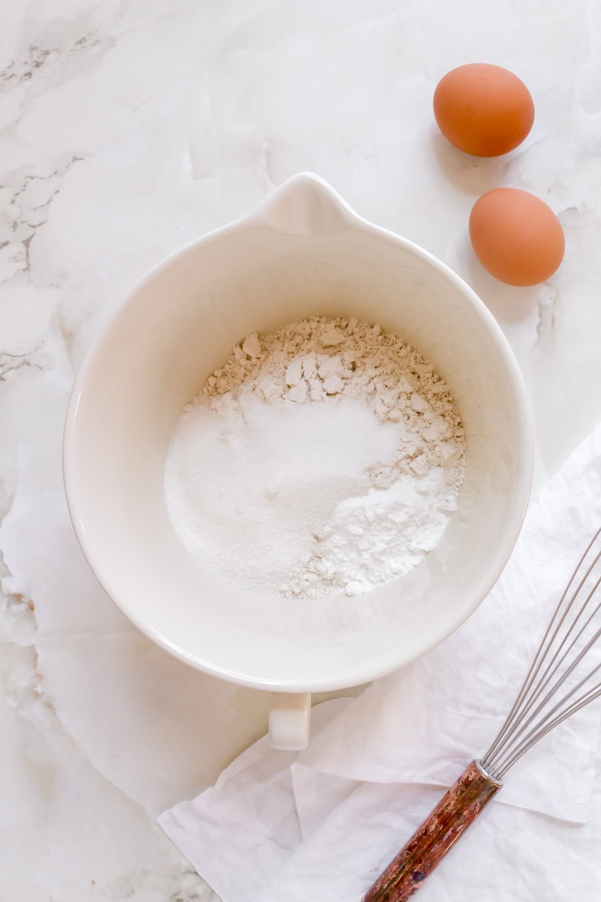 dry ingredients for gluten free pancakes in a white ceramic bowl.