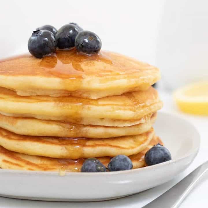 light and fluffy lemon pancakes with blueberries and maple syrup