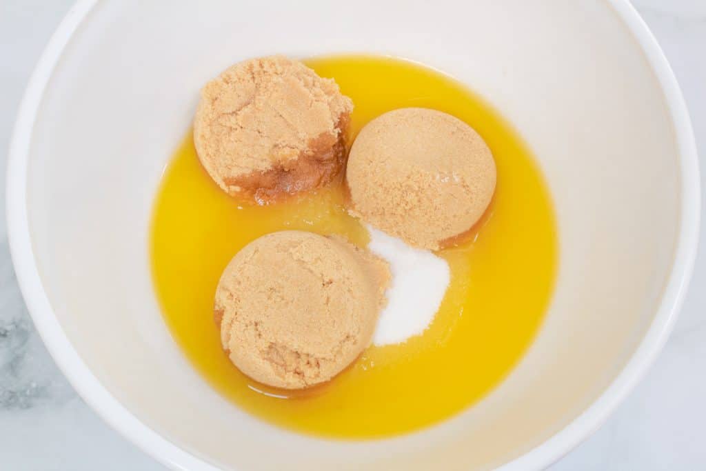 melted butter with sugar in a white mixing bowl.
