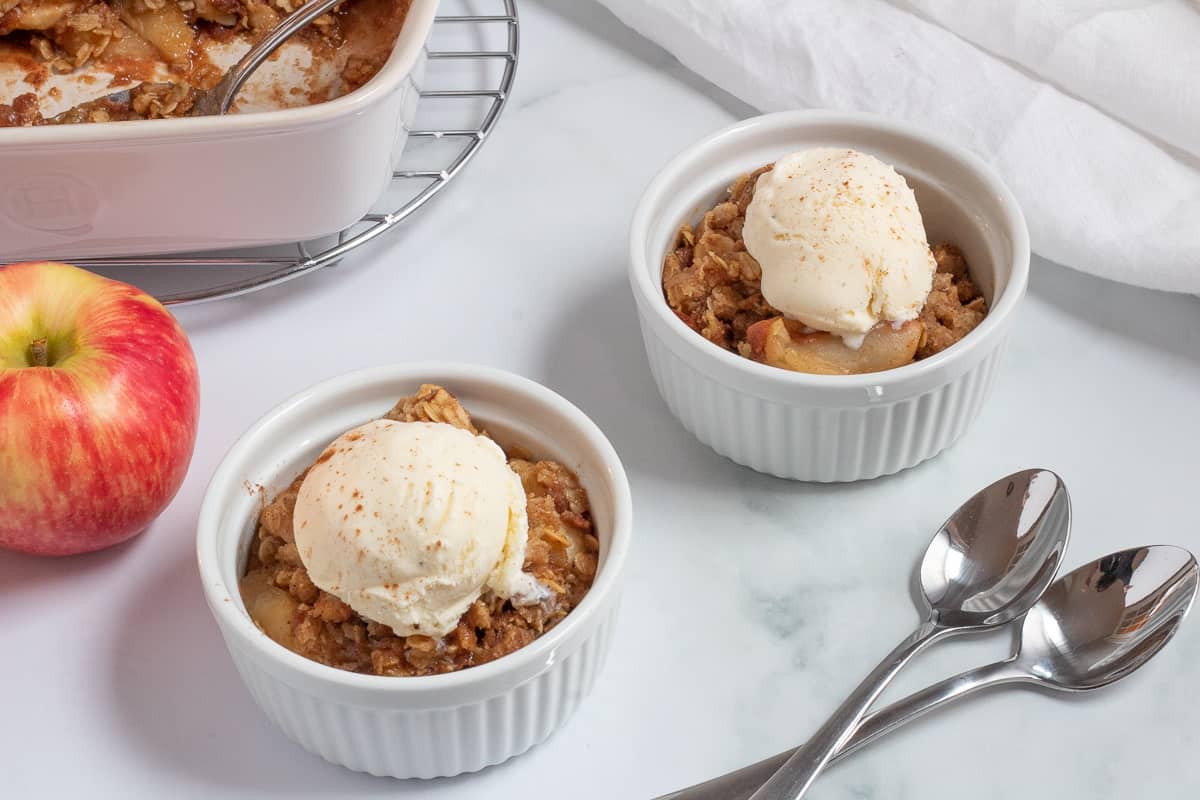 two bowls of brown butter apple crisp