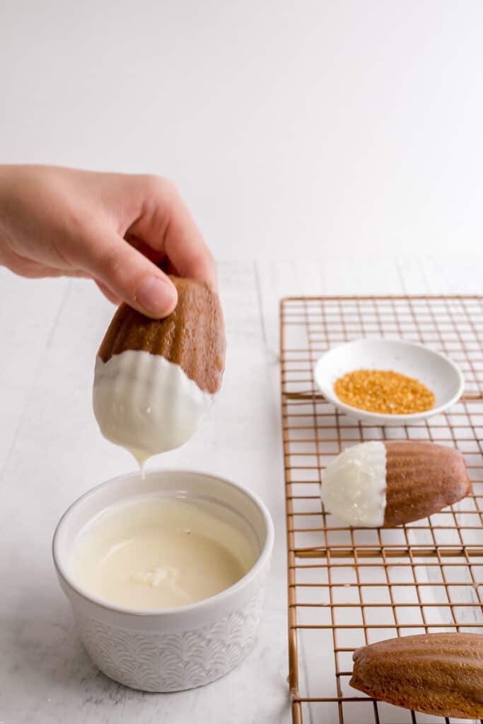 dipping madeleines in white chocolate