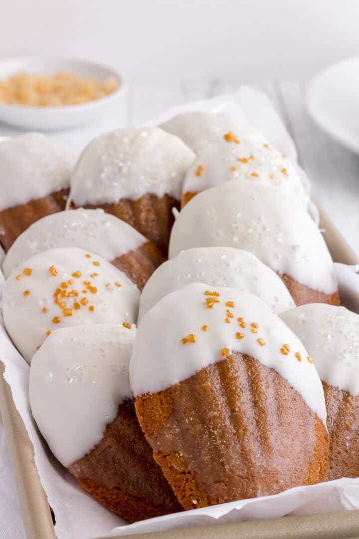 chocolate dipped ginger madeleines in gold bread pan 
