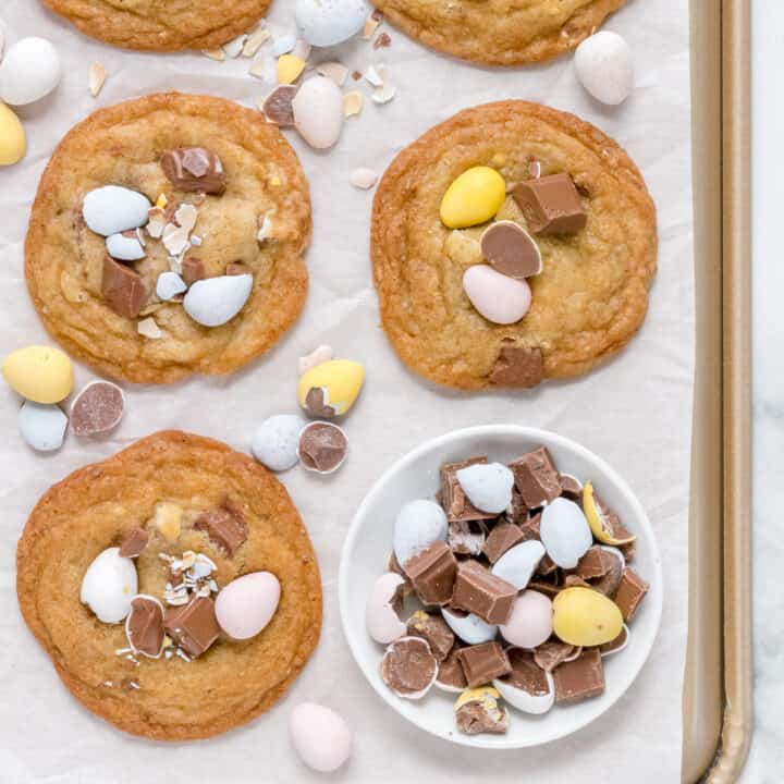 Cadbury Chocolate chip cookies on baking sheet with parchment paper and mini eggs