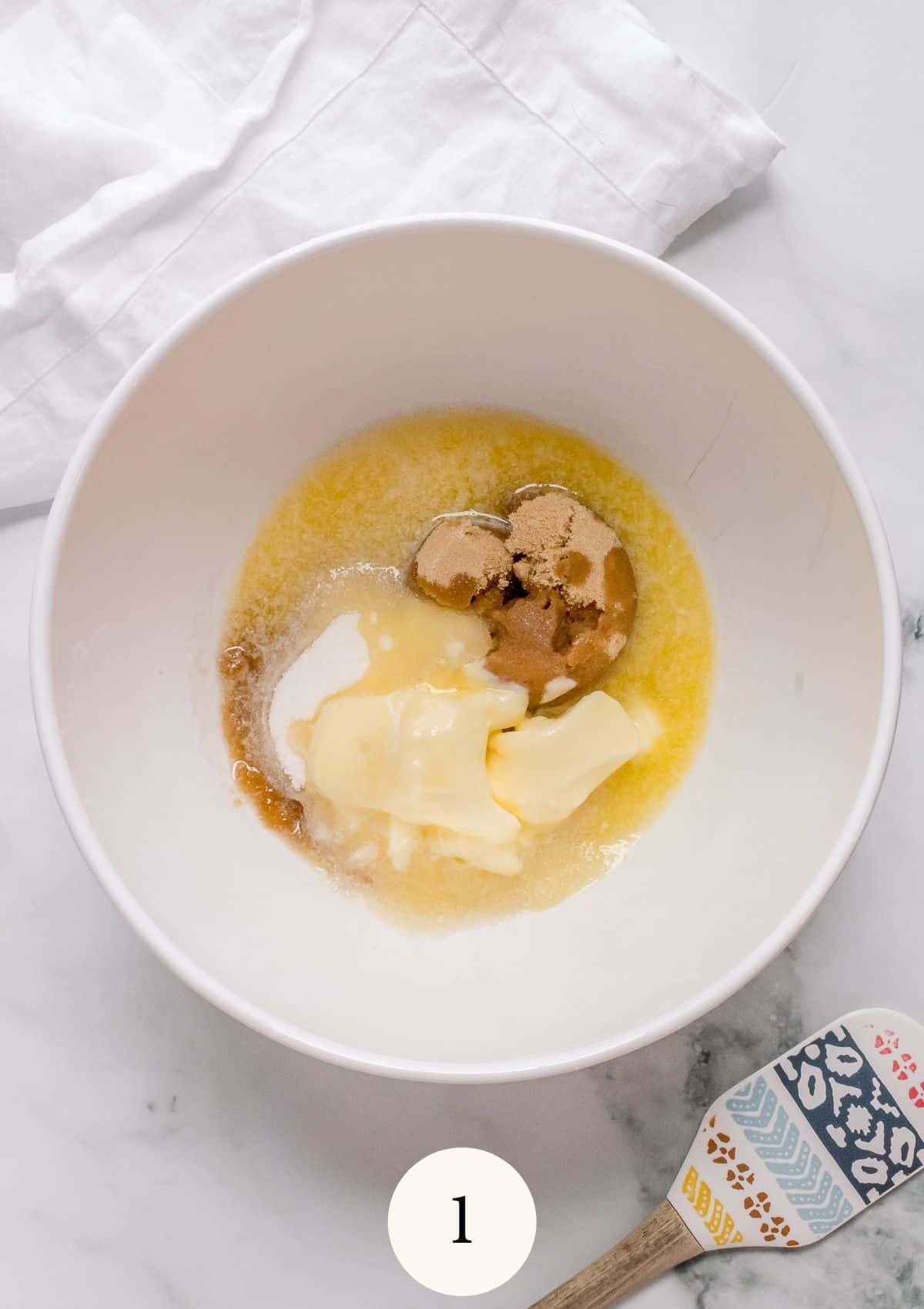 melted butter with sugar in white mixing bowl
