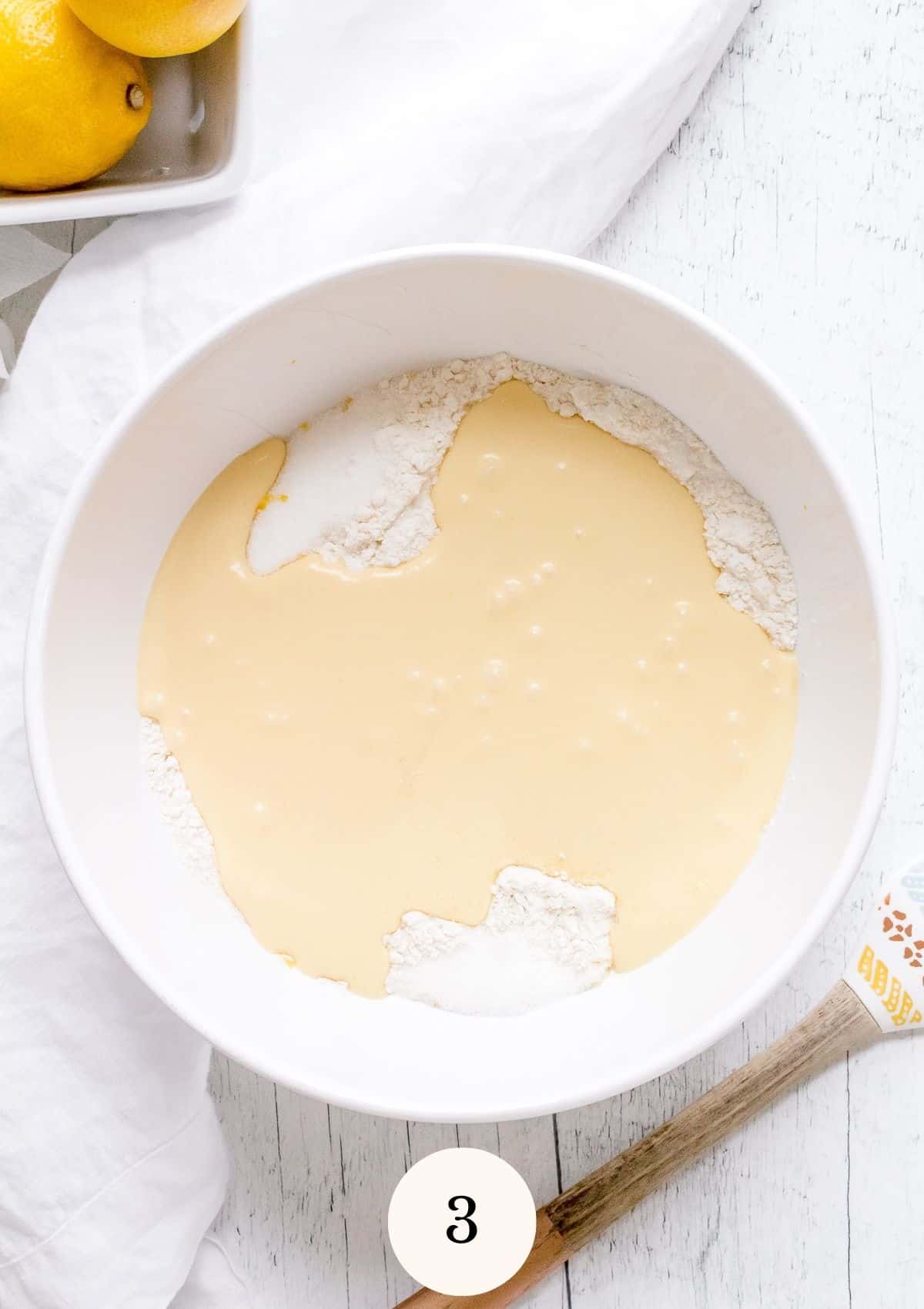 combined wet and dry ingredients in white mixing bowl