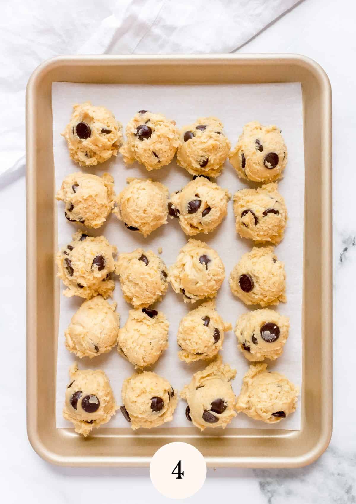 cookies dough scoops arranged on a baking sheet