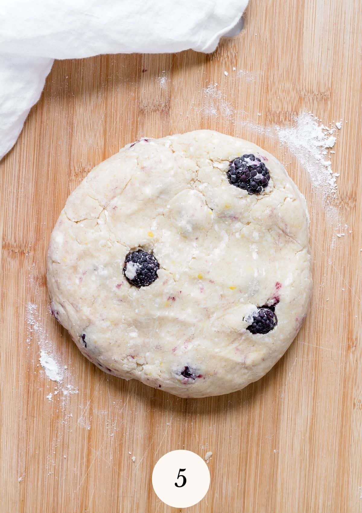 circle of gluten free scone dough on cutting board