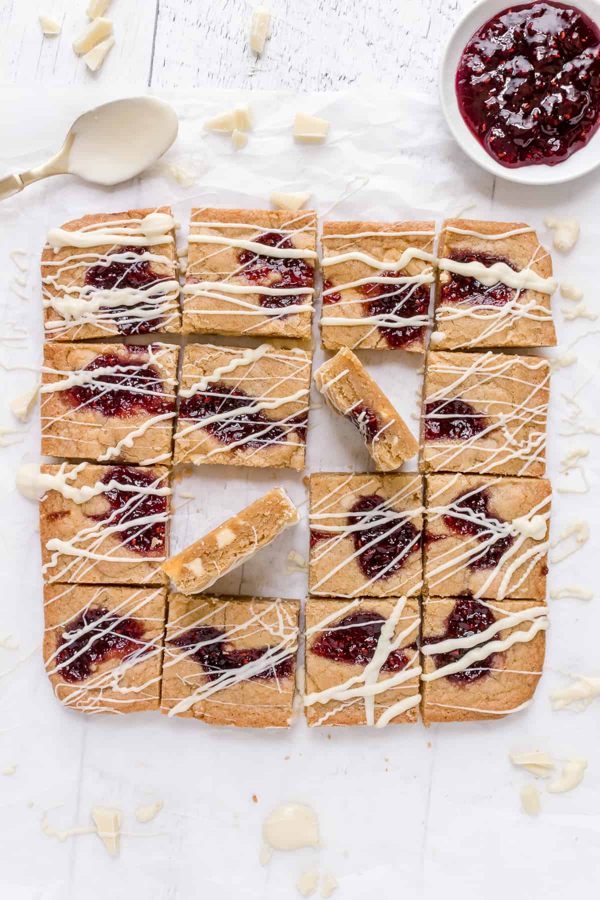 raspberry white chocolate blondies on parchment paper