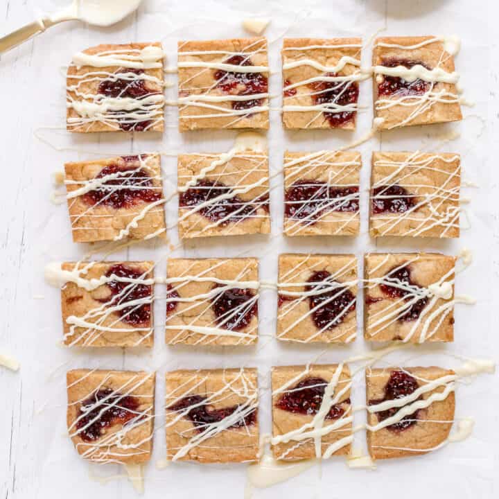 white chocolate and raspberry blondies on parchment paper