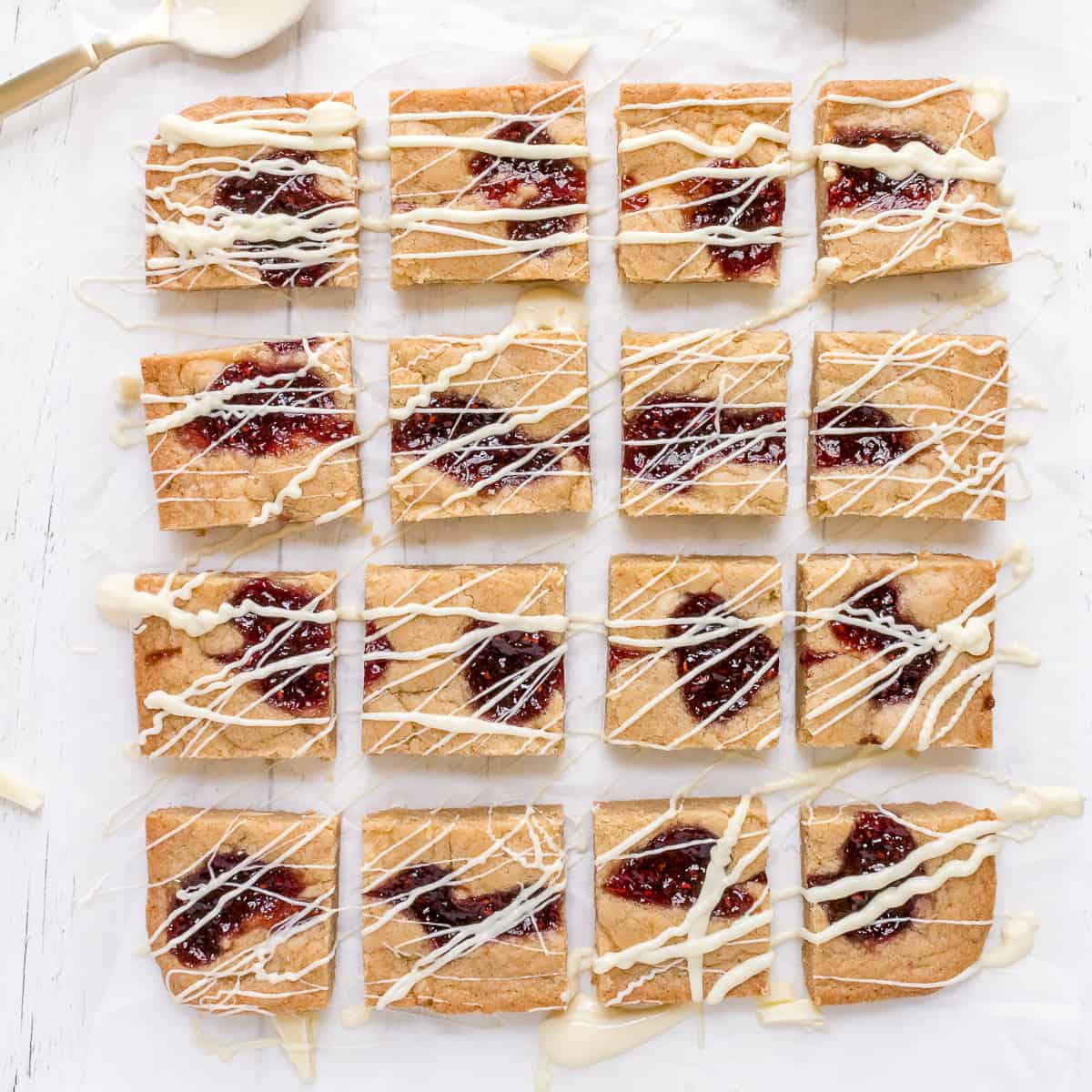 white chocolate and raspberry blondies on parchment paper
