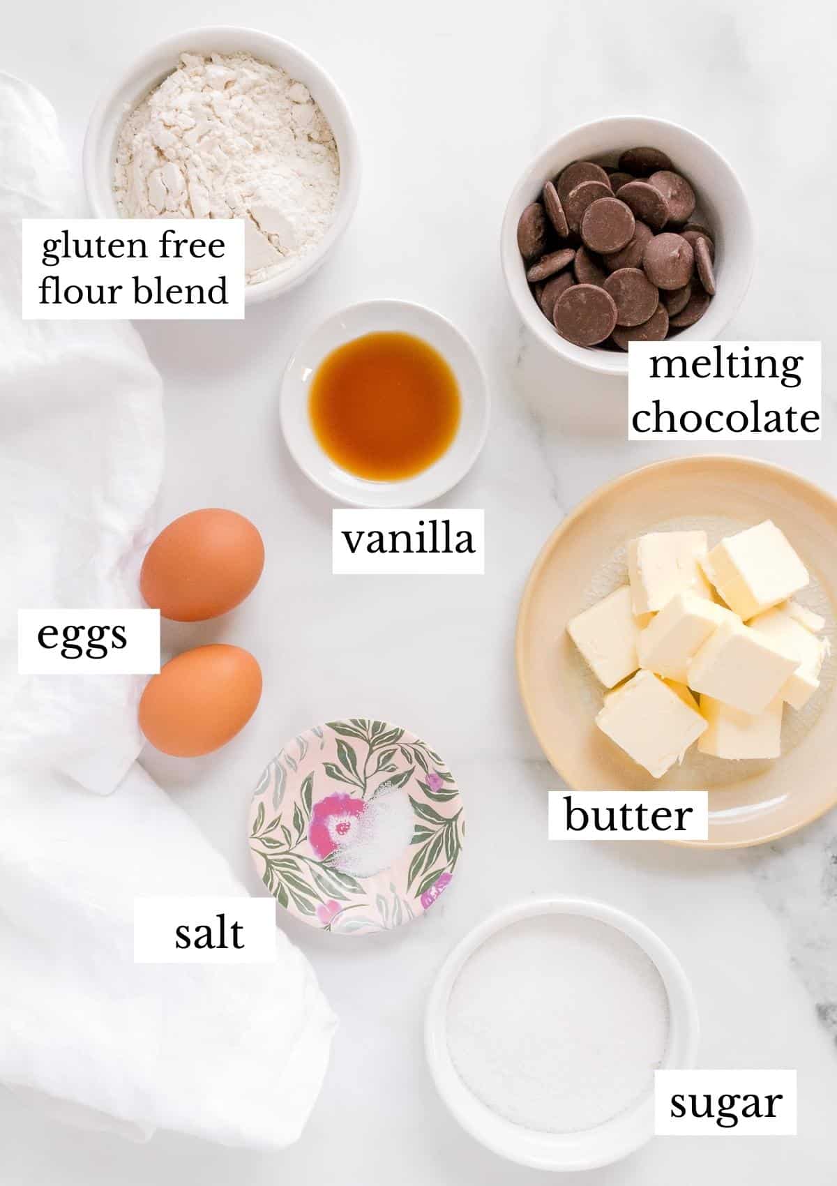 ingredients for gluten free madeleines on white background.