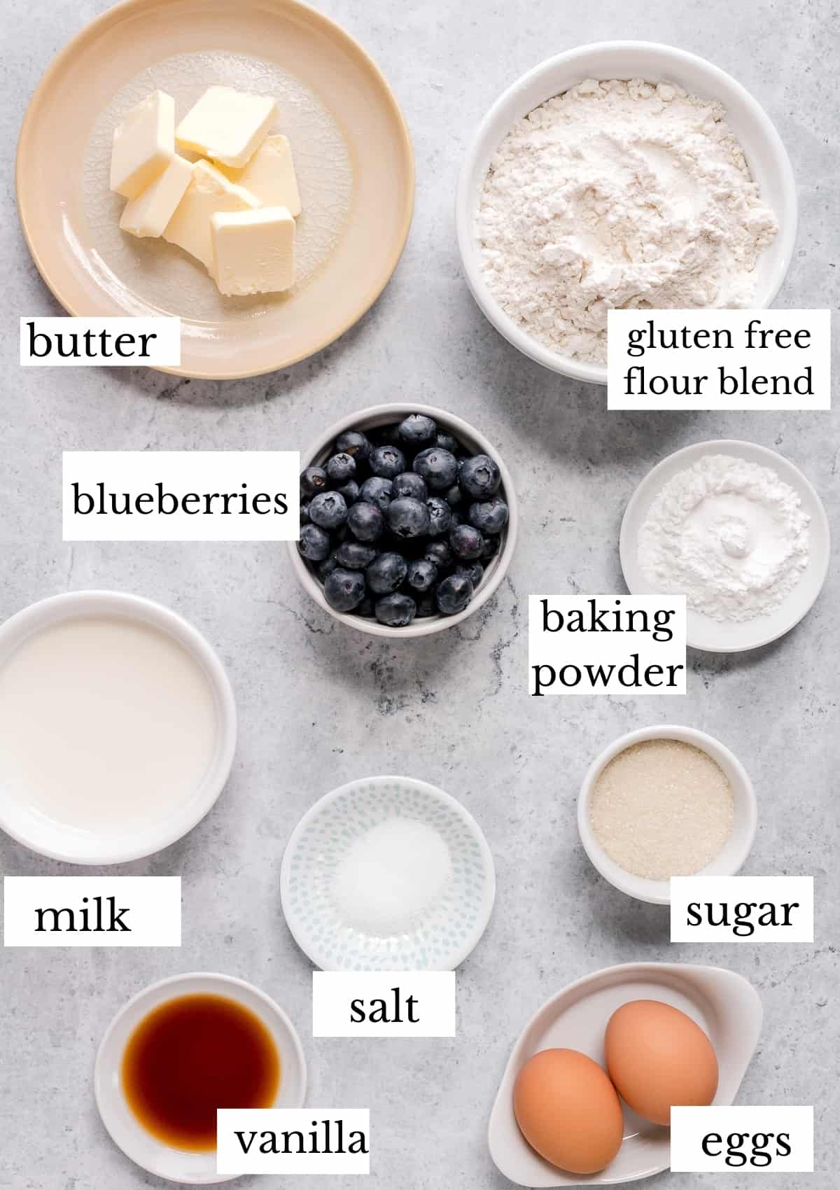 ingredients for gluten free blueberry pancakes on gray marble