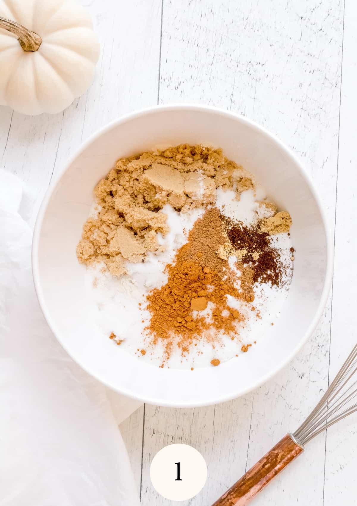 dry ingredients for pumpkin bread in white mixing bowl