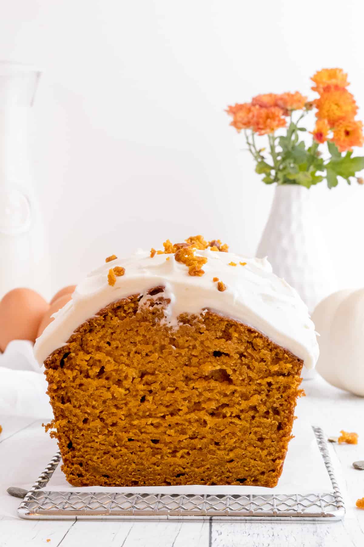 sliced pumpkin bread with cream cheese frosting