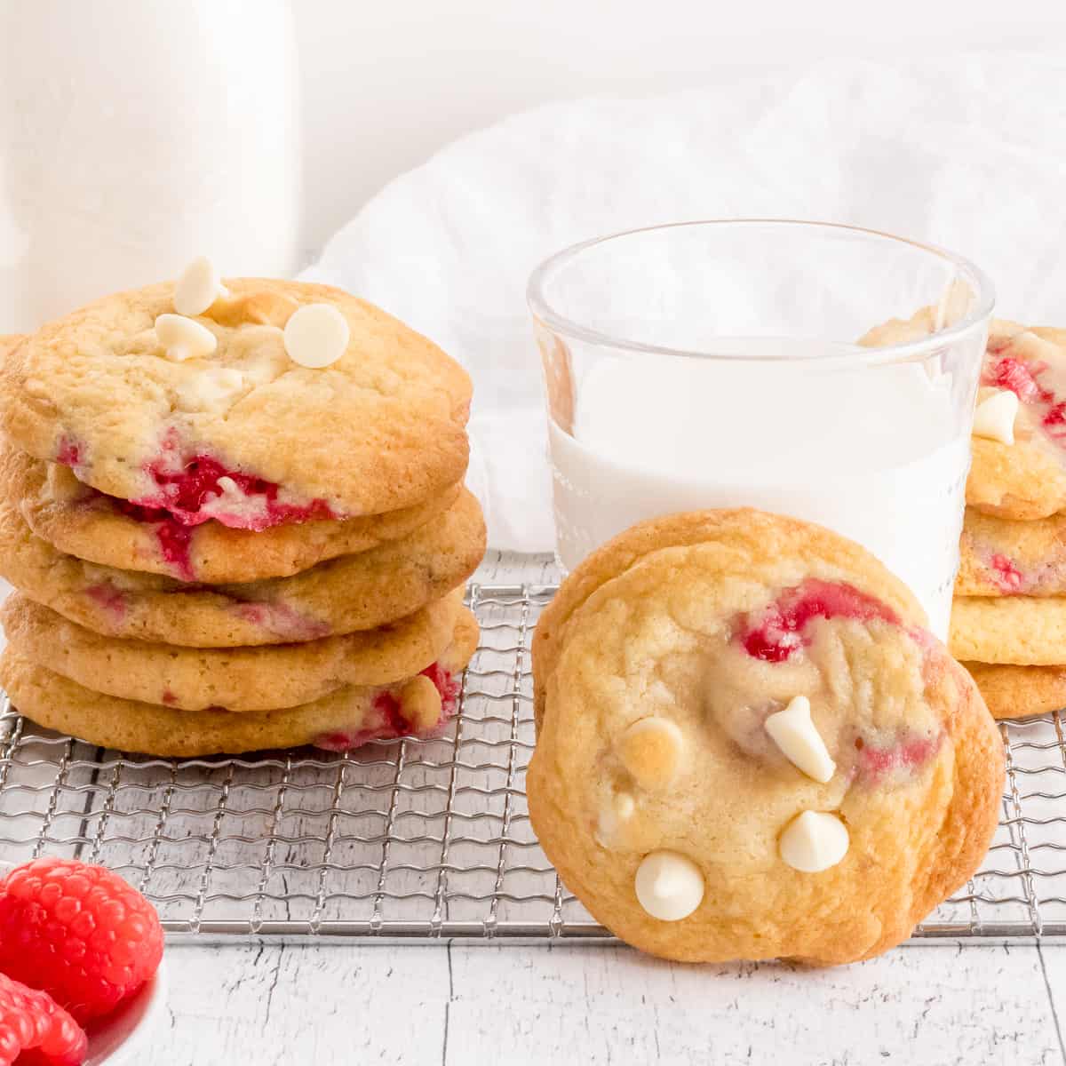 white chocolate and raspberry cookies with glass of milk.