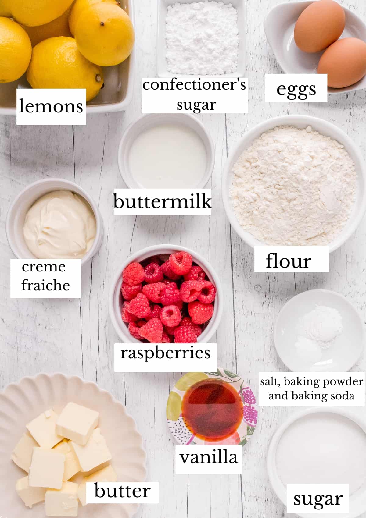ingredients for lemon raspberry loaf cake on white barn board