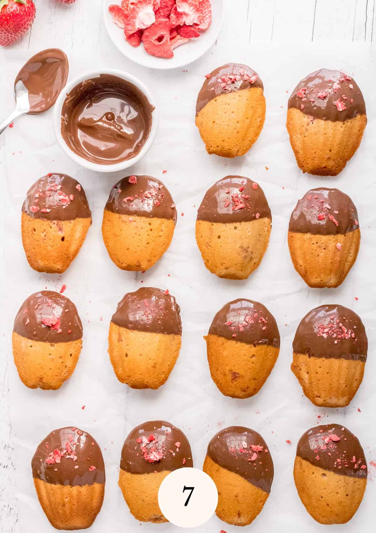 dipping madeleines in chocolate.
