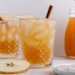 apple cider whiskey cocktail with garnishes.