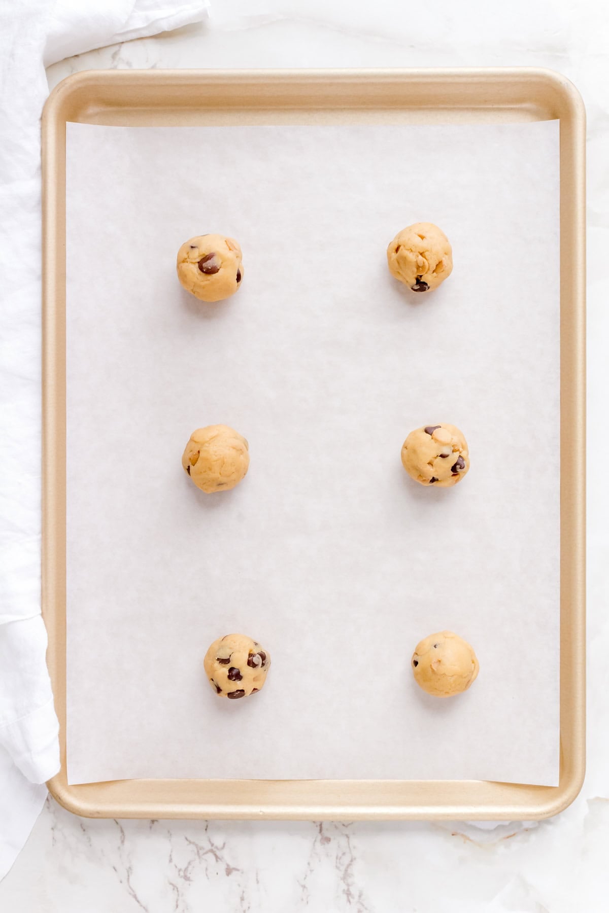 peanut butter chip and chocolate chip cookie dough on baking sheet.