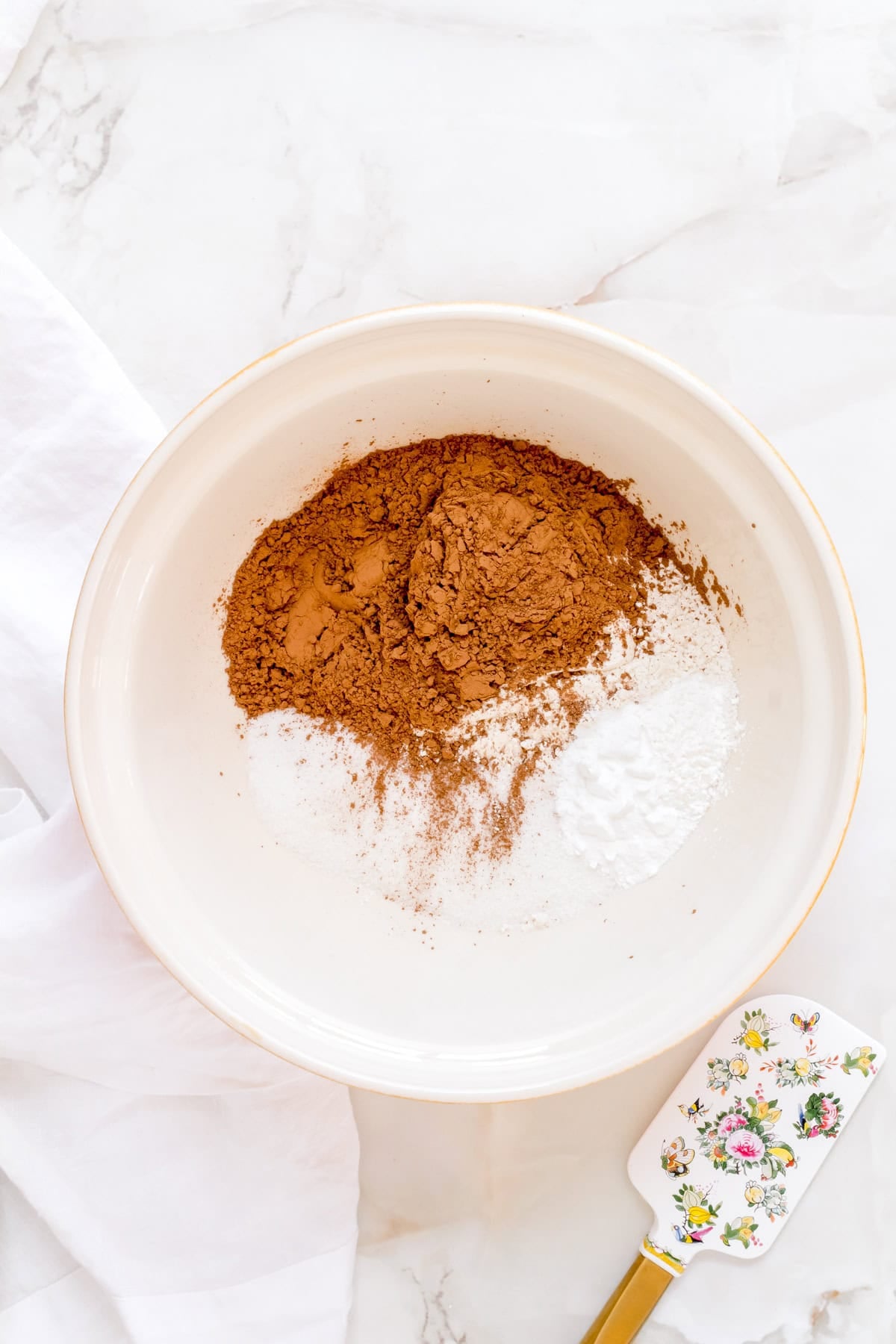 dry ingredients for chocolate waffles in white mixing bowl.