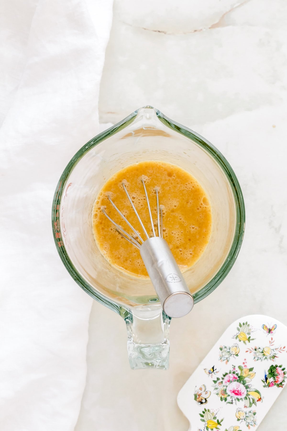 eggs and canola oil mixed in large measuring cup.