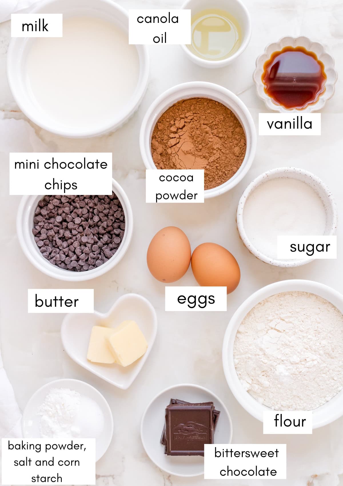 labeled ingredients for chocolate waffles on marble counter.