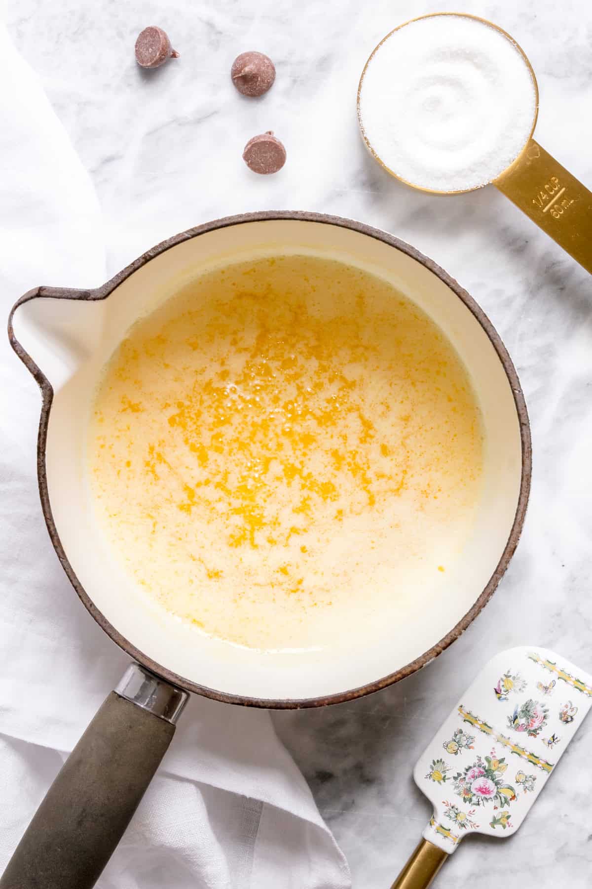 butter melting in white saucepan for brown butter.