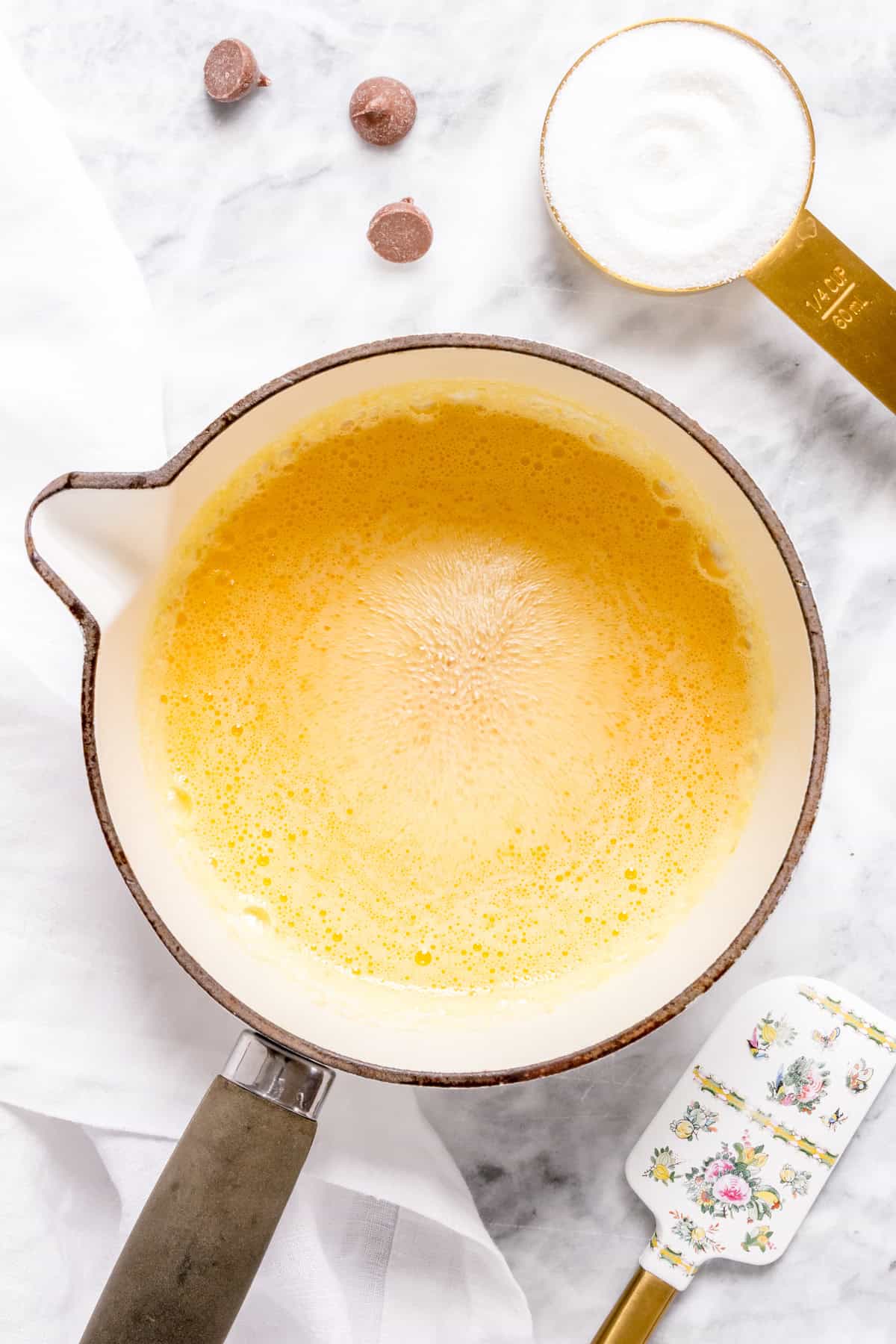 butter melting in white saucepan for brown butter.