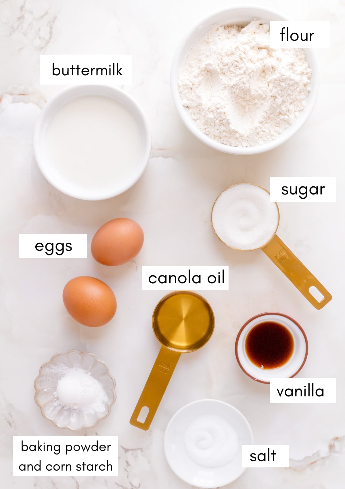 labeled ingredients for buttermilk waffles on white marble counter.