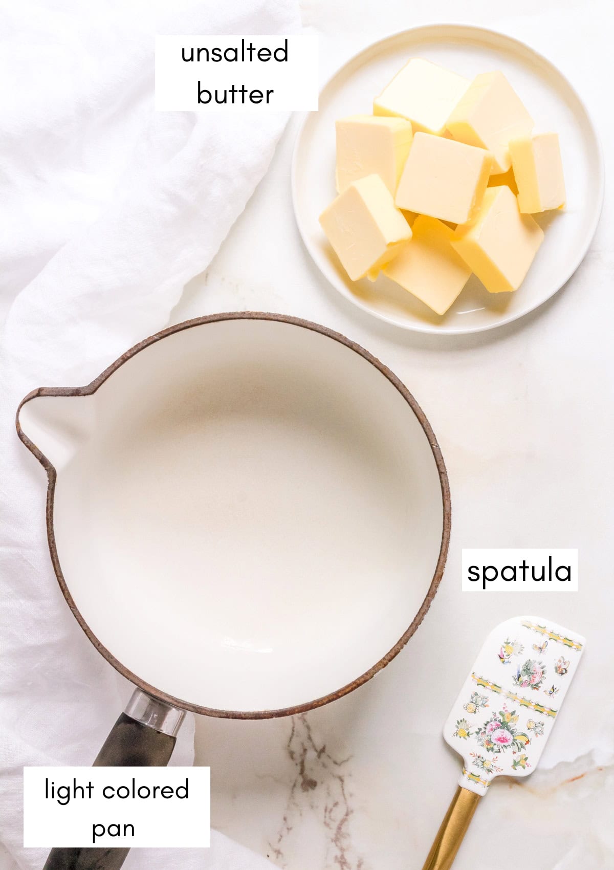labeled ingredients and equipment of making brown butter on white background with a white napkin.

