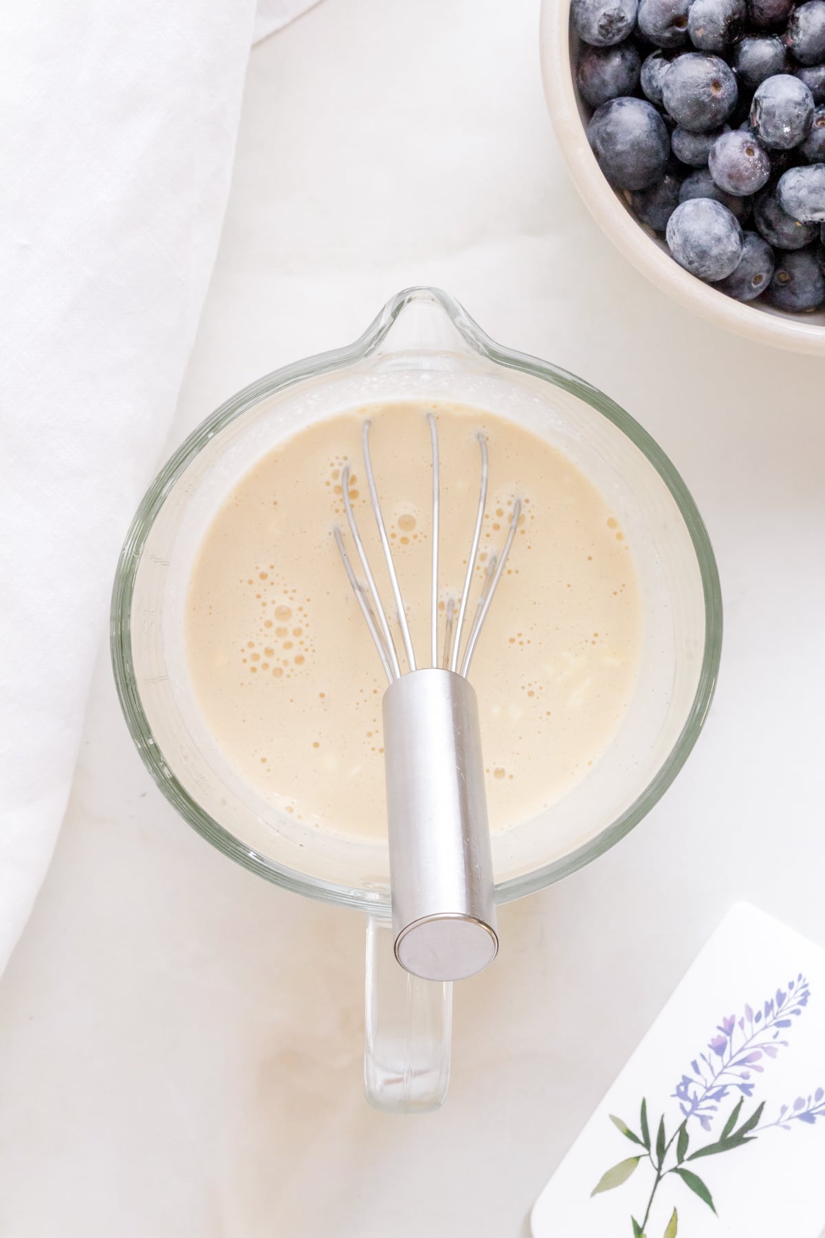 liquid ingredients for blueberry scones in measuring cup.
