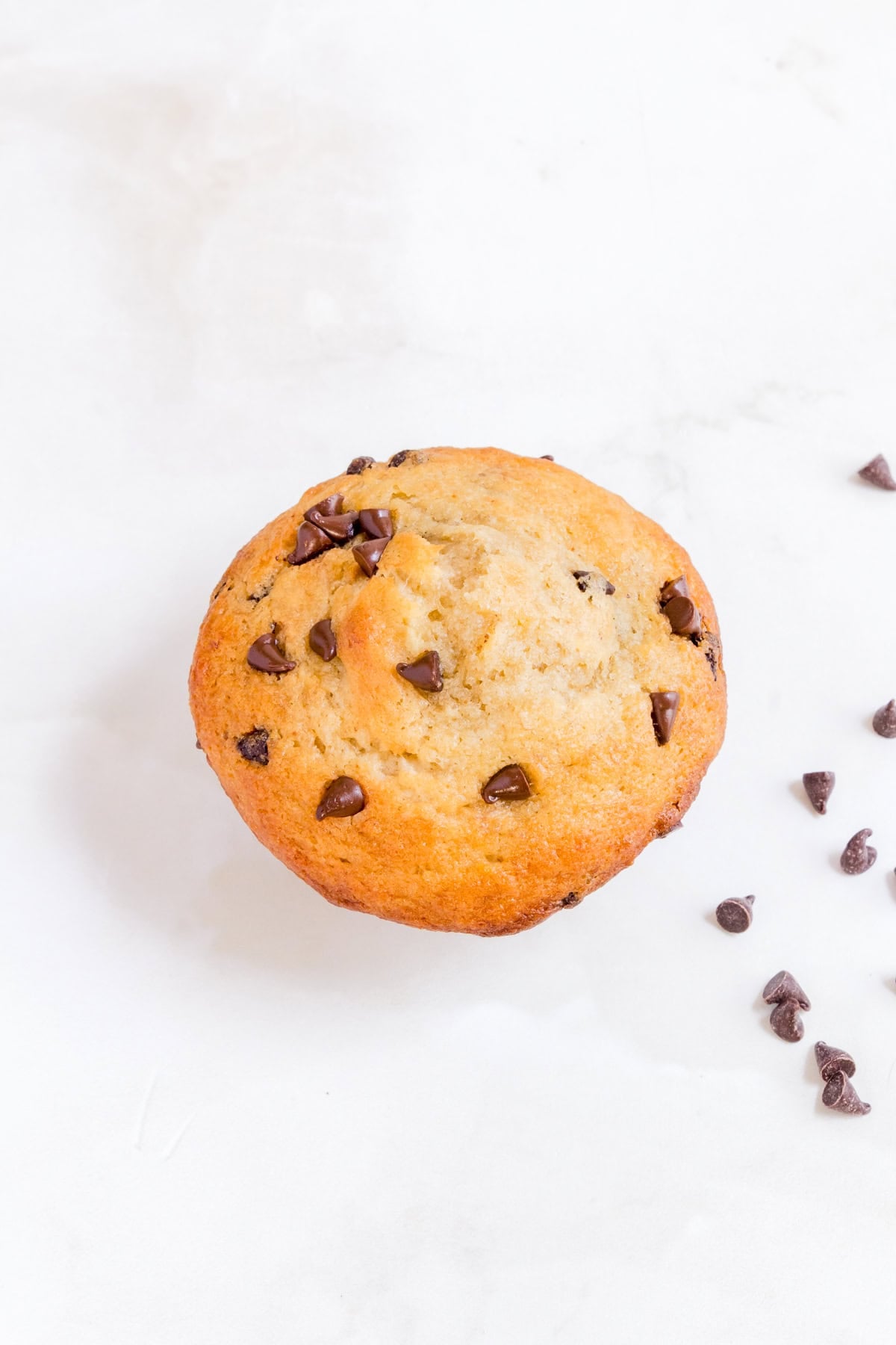 chocolate chip banana muffin on white counter.
