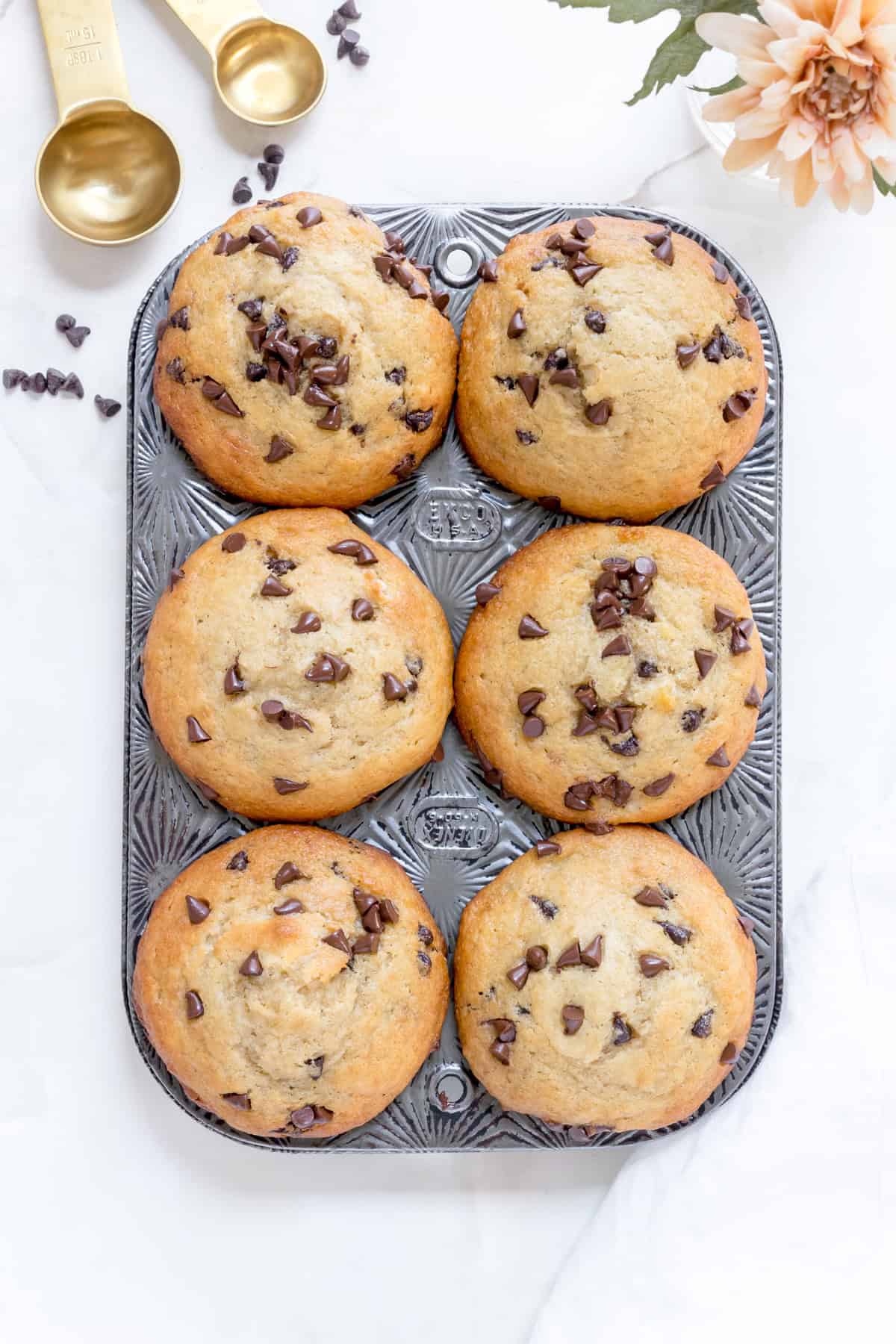 banana chocolate chip muffins baked in muffin pan.
