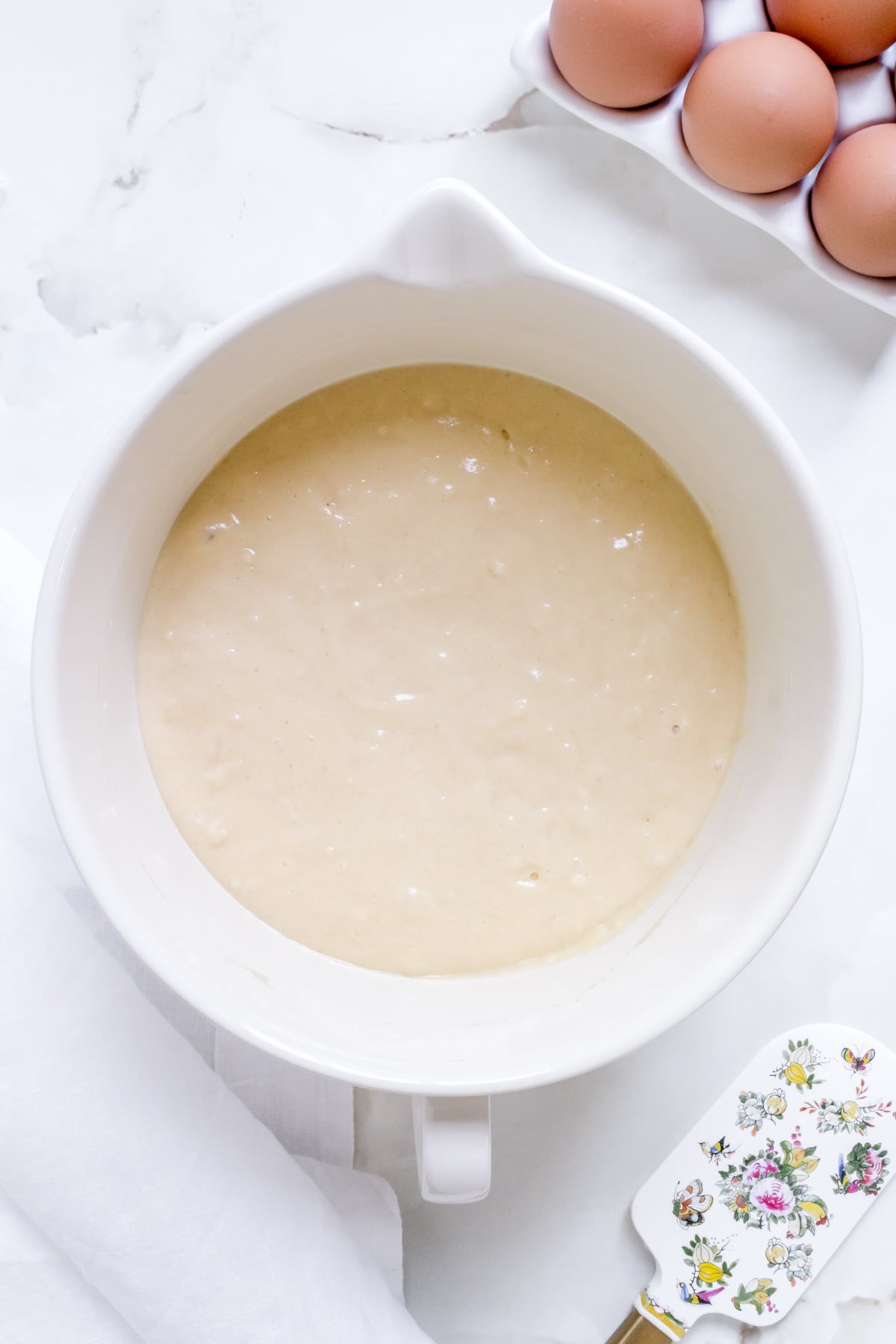 batter for discard pancakes in white mixing bowl.