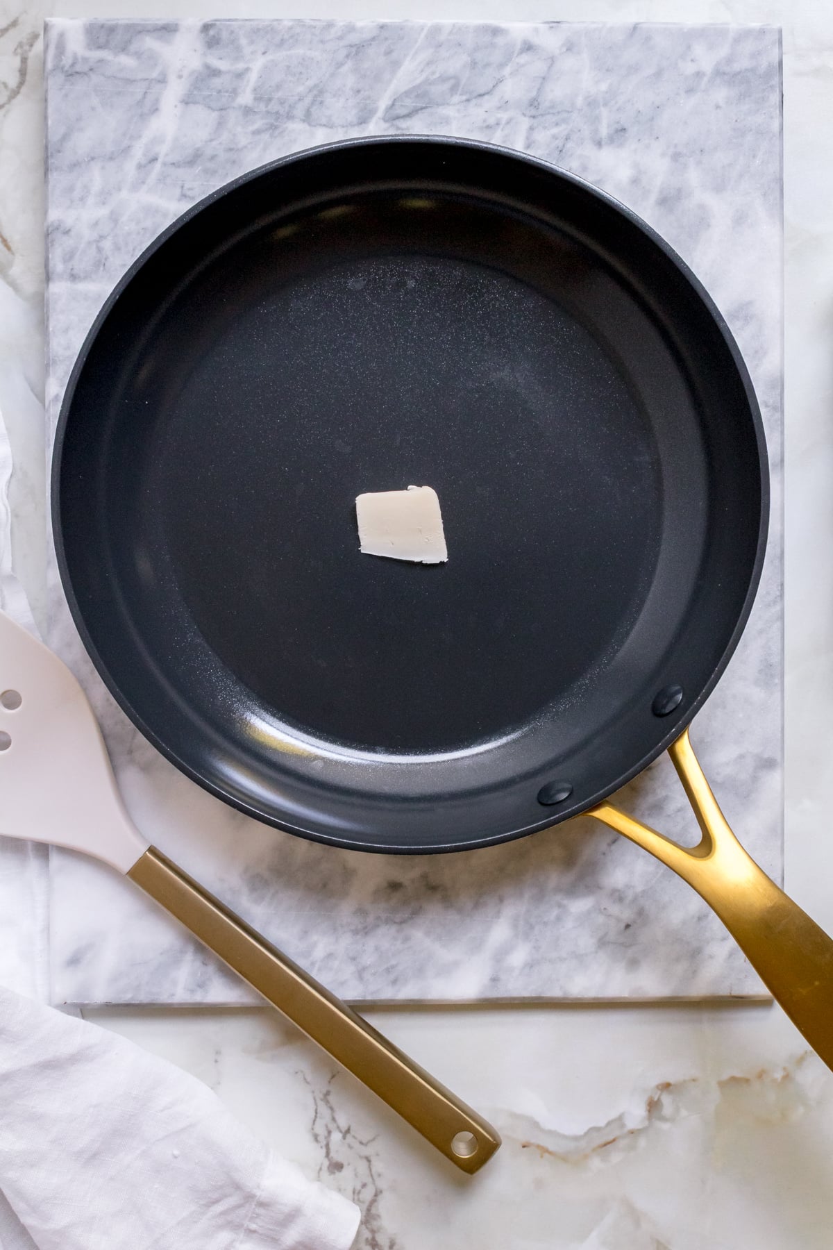 frying pan with butter warming for discard pancakes. 