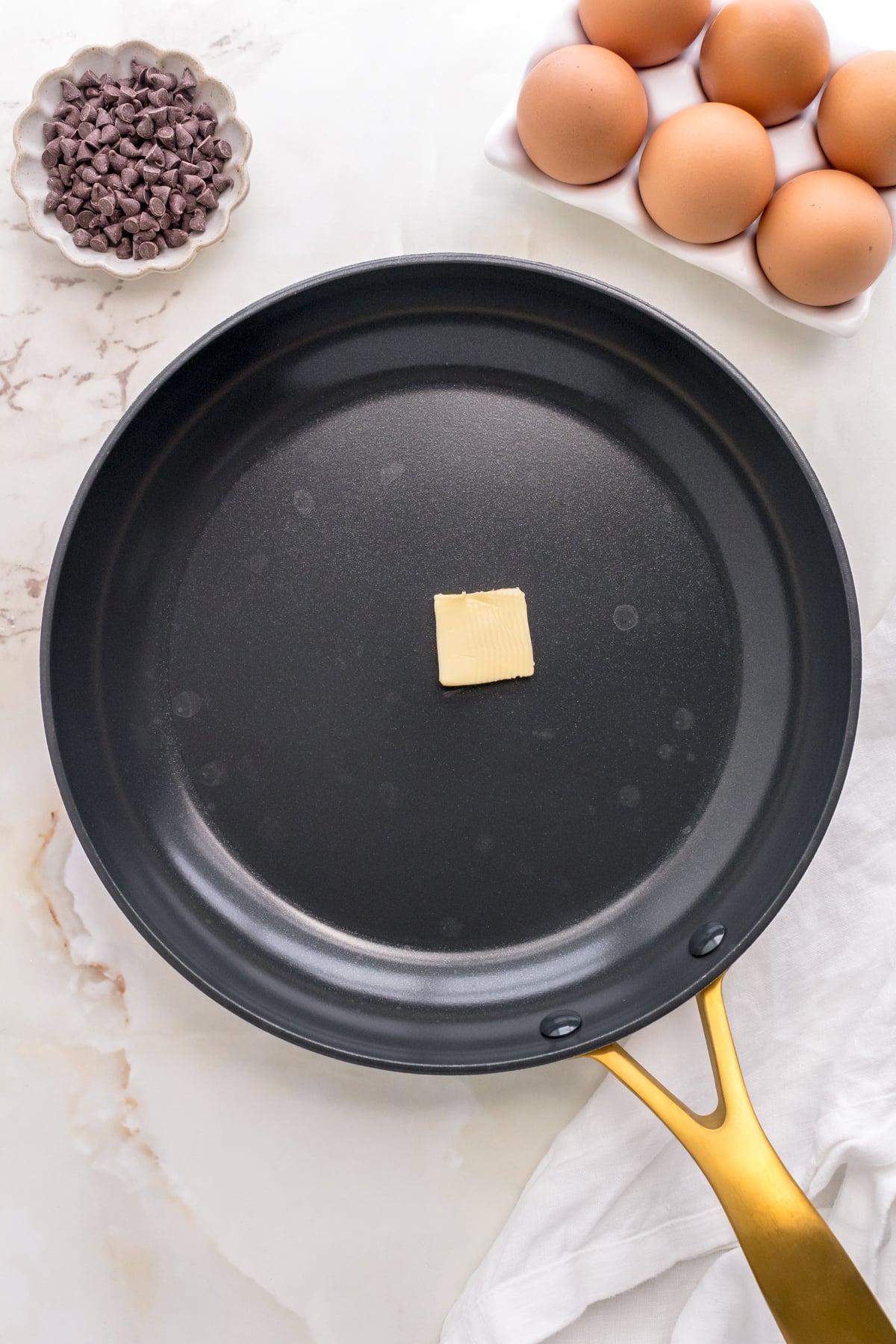 warming butter in pan for chocolate chip pancakes.
