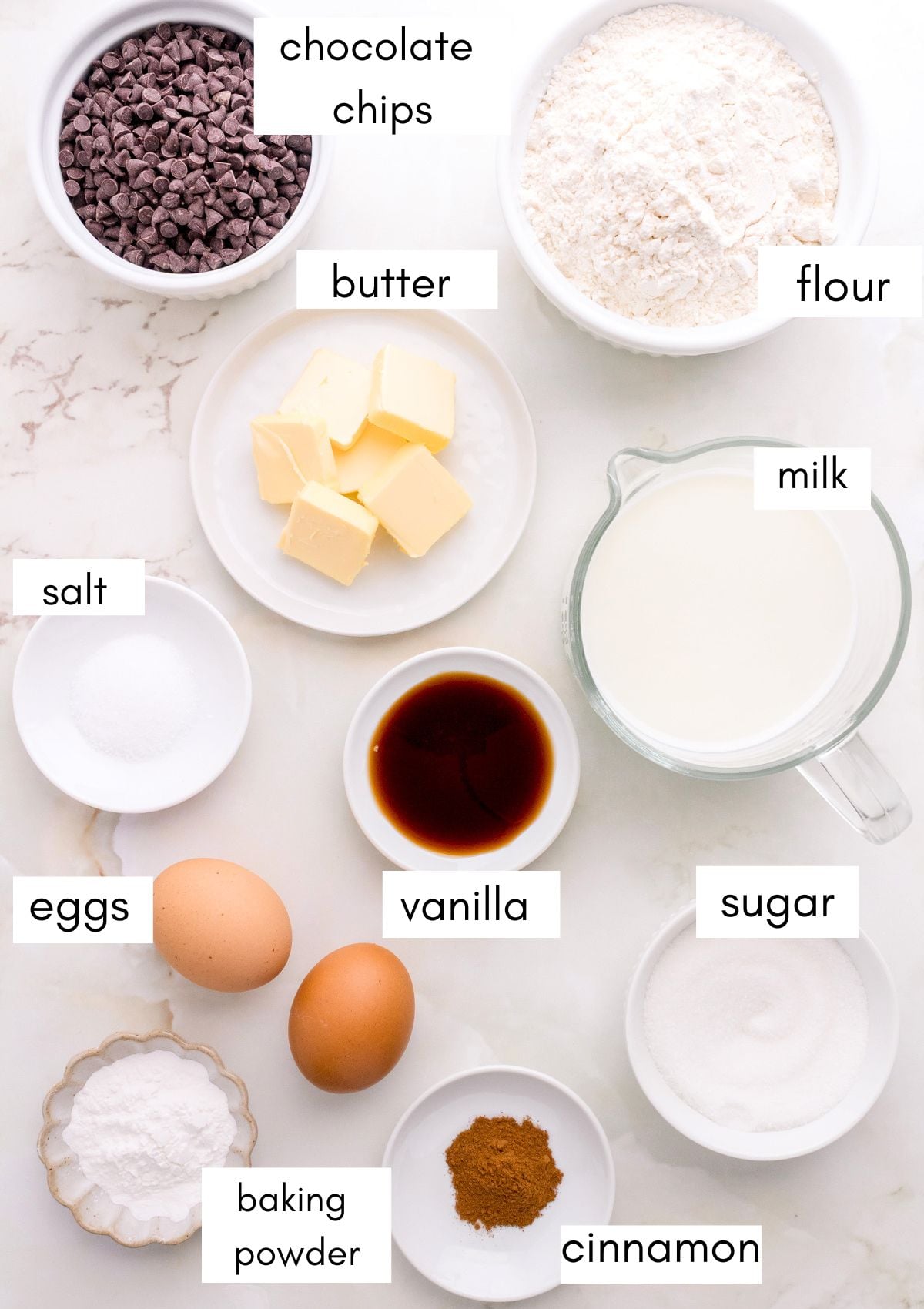 labeled ingredients for chocolate chip pancakes on white marble counter.