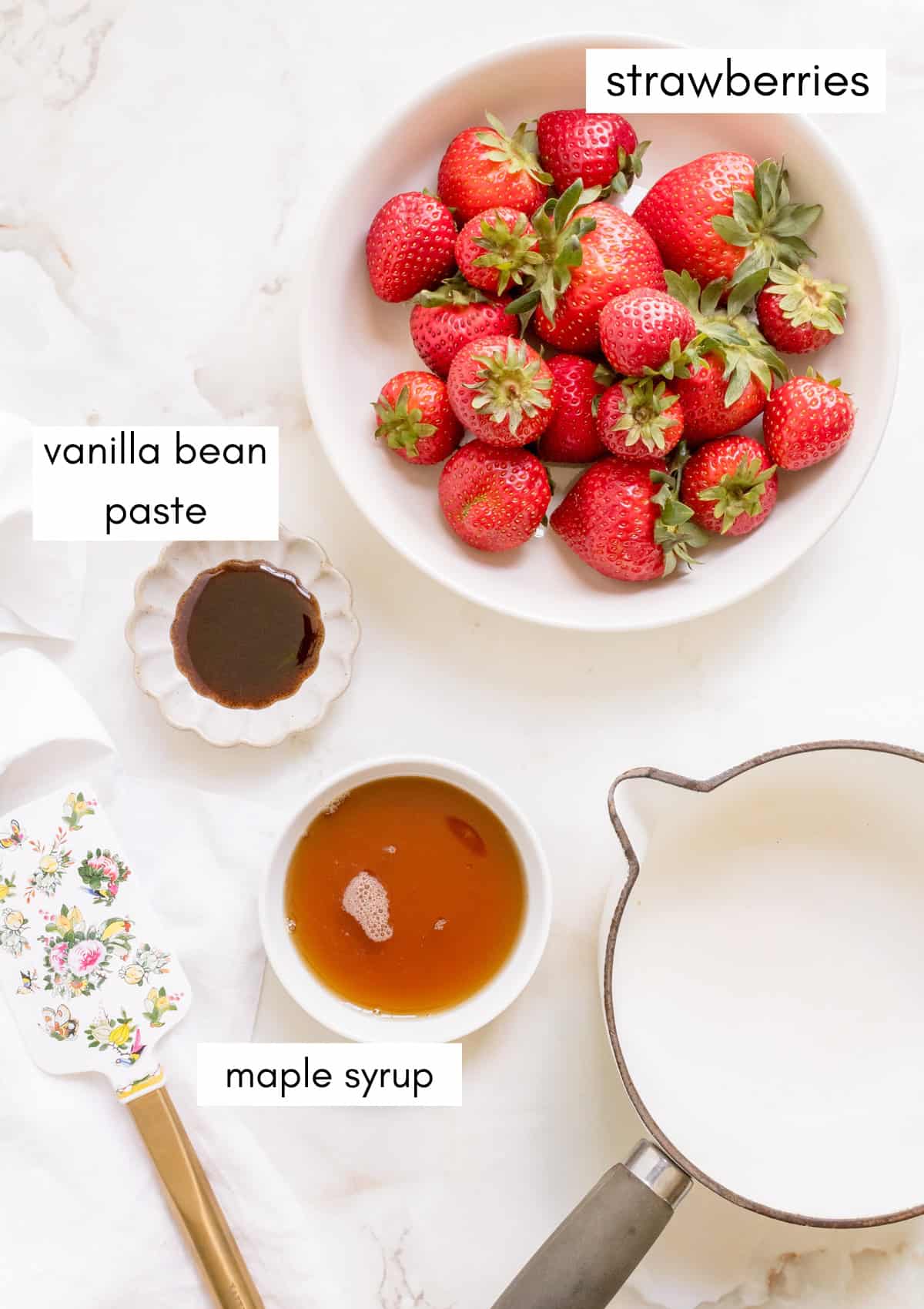 labeled ingredients for strawberry compote on white marble counter.