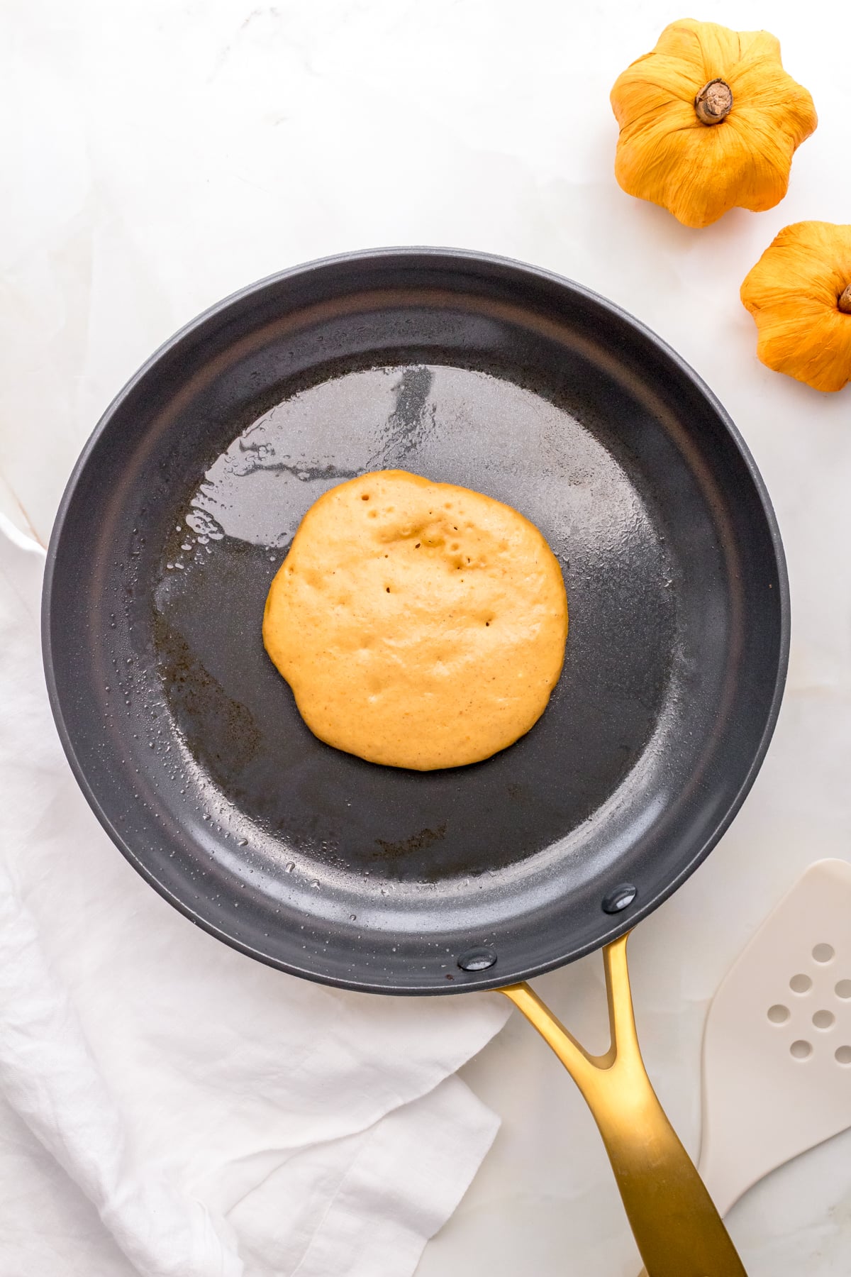 batter for pumpkin pancakes in nonstick frying pan.