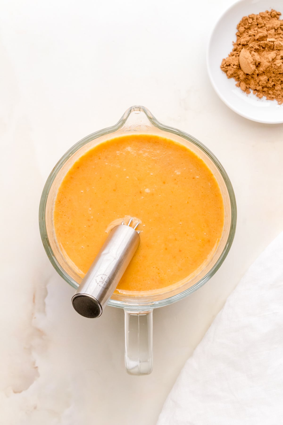 melted butter, pumpkin puree, eggs, vanilla, and milk in a large measuring cup.
